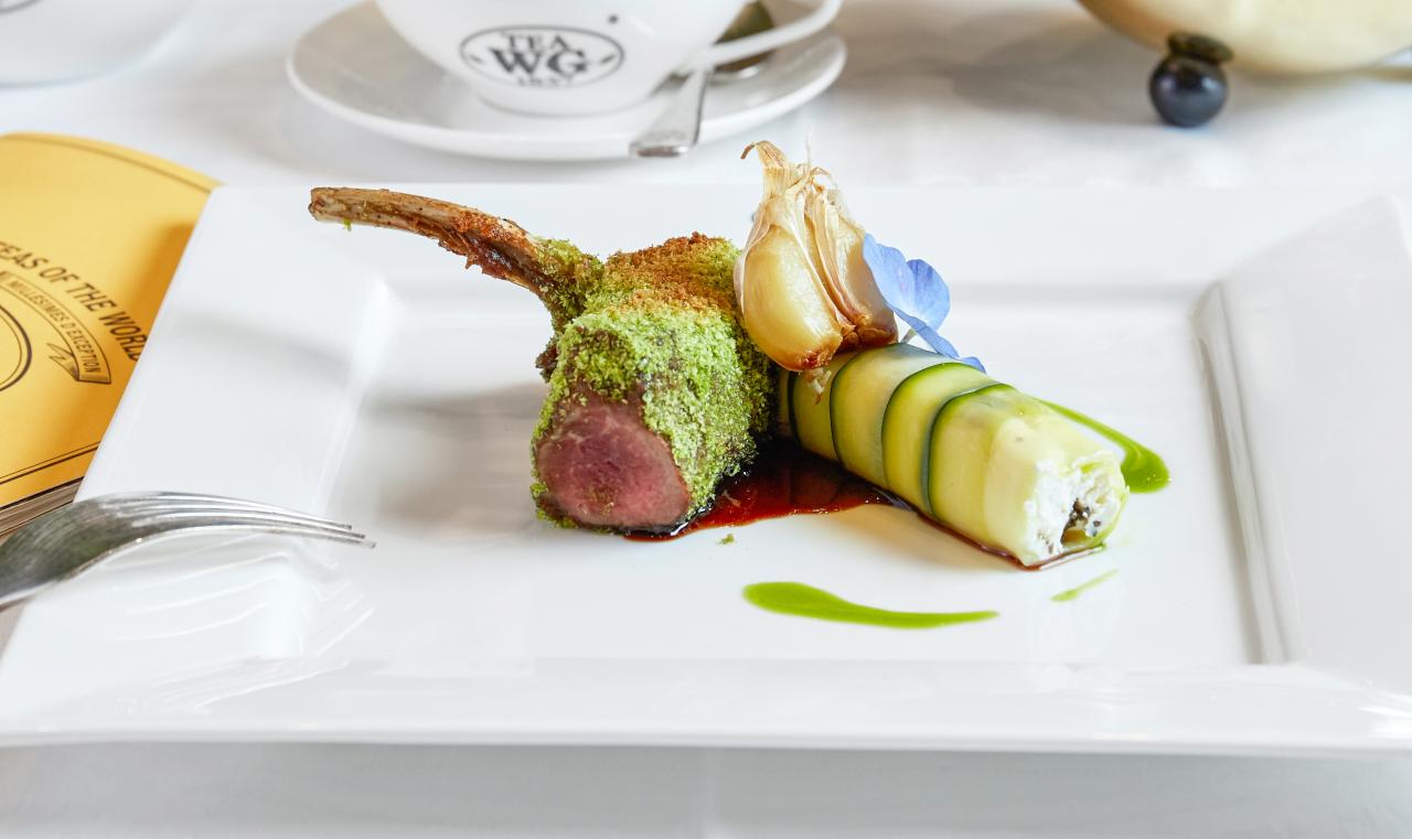 Herb coated lamb rack with zucchini cannelloni stuffed with goat cheese, olive and mint
